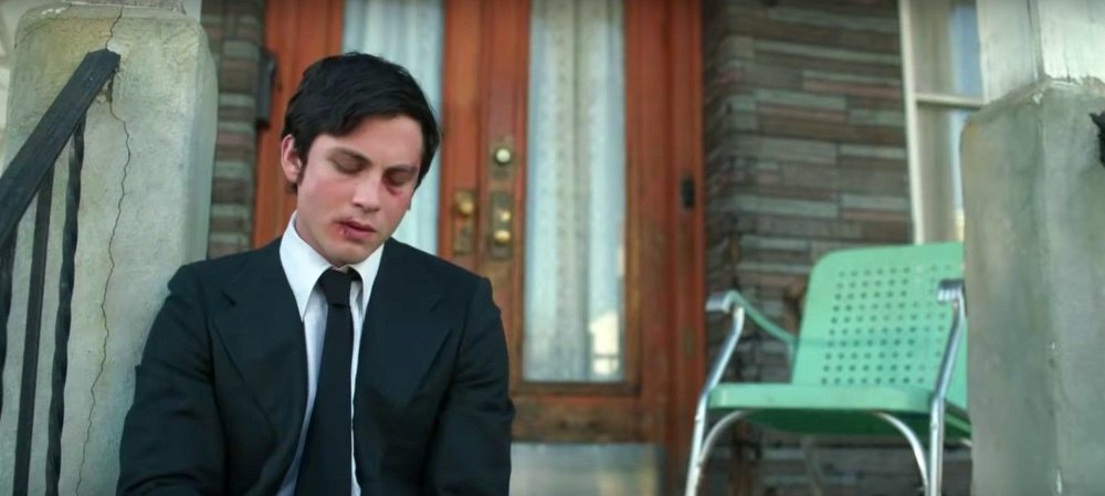 guy with face wound looking down