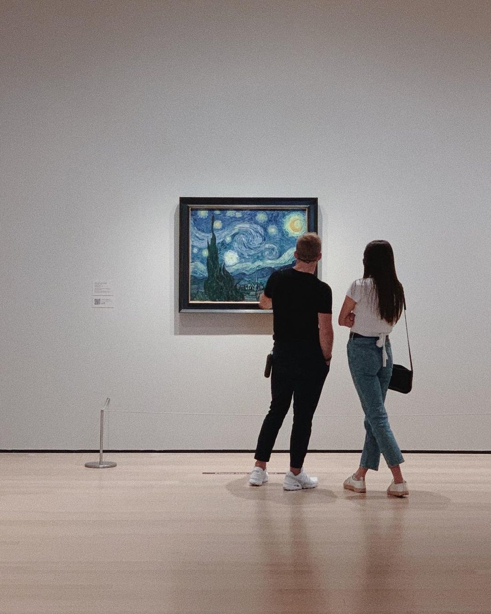 people admiring a van gogh painting