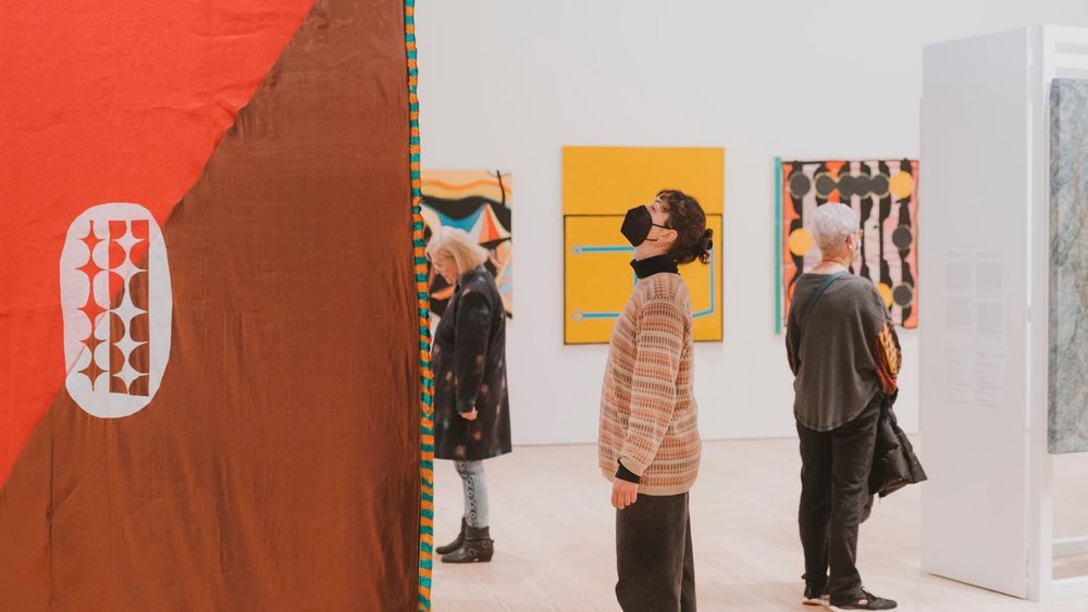 A lady looking at an artwork inside The Whitney Museum of American Art