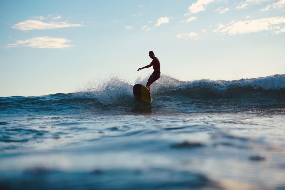 man surfing in ala moana bowls