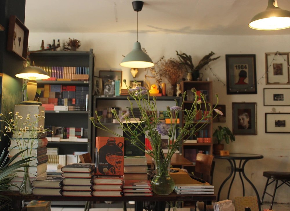 Books and flower base in table