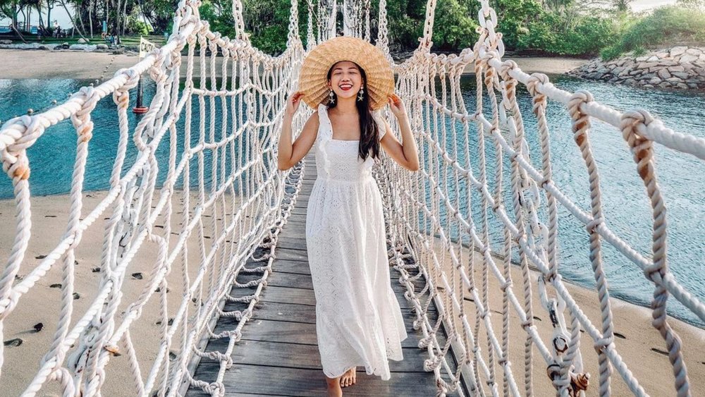 Pose by the famous hanging bridge over the sand and waters of Palawan Beach Sentosa Island. Credits: @blushblushtomato on Instagram