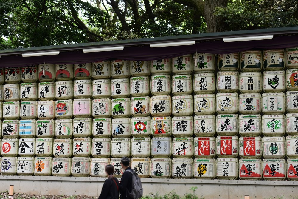 Visitors of the Meiji Shrine looking at the sake barrels on display