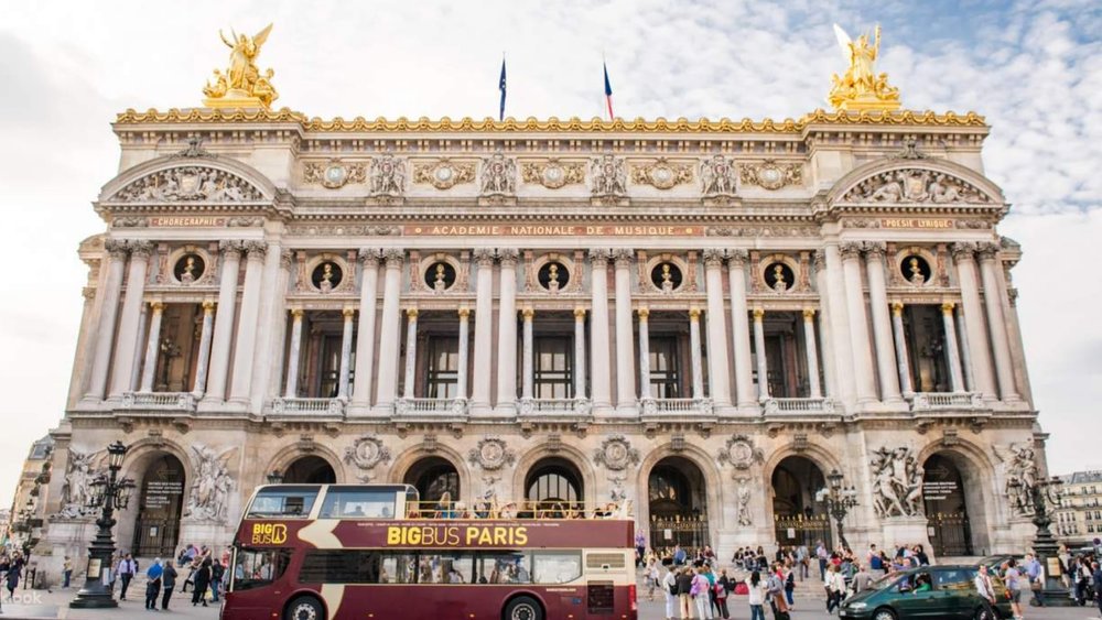 See the buildings at a great angle, thanks to the open-top deck of the tour bus.
