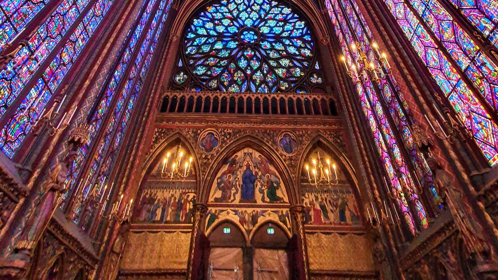 Read the Bible stories depicted on the stained glass windows from top to bottom. Credit: alyofthecross