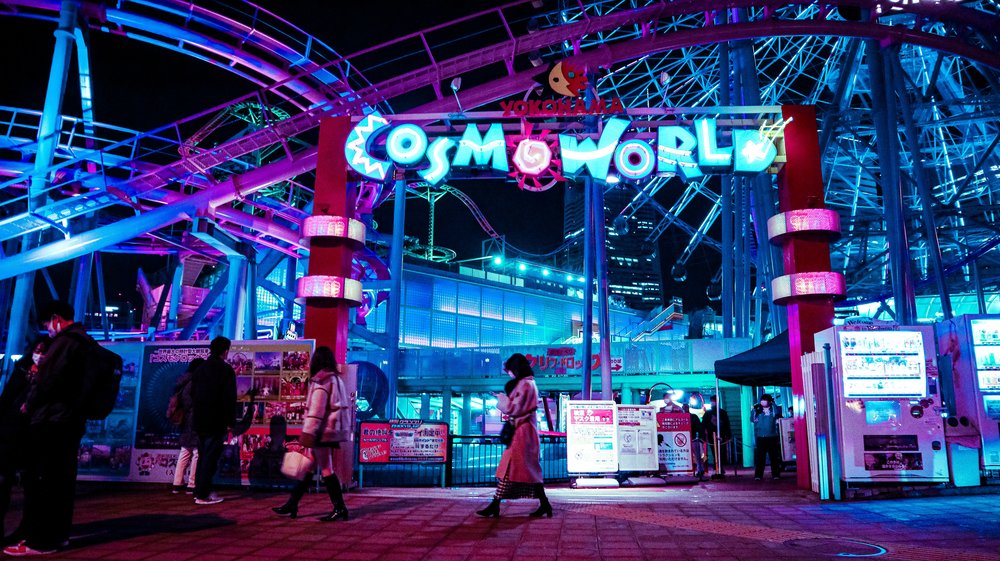 the neon signs of Yokohama Cosmo World lit up at night, japan