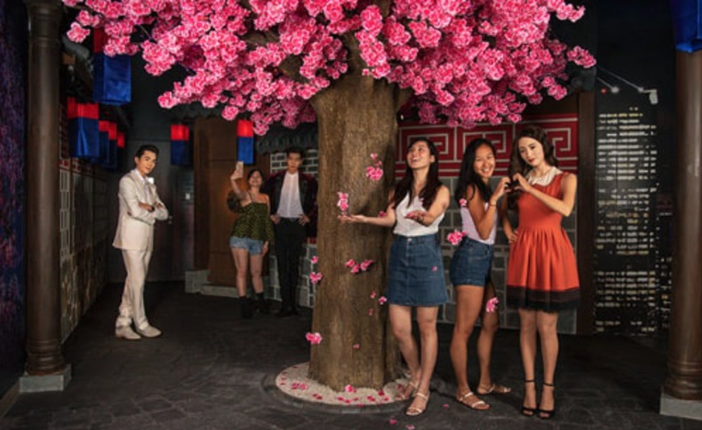 tourists enjoying madame tussauds singapore wax figures