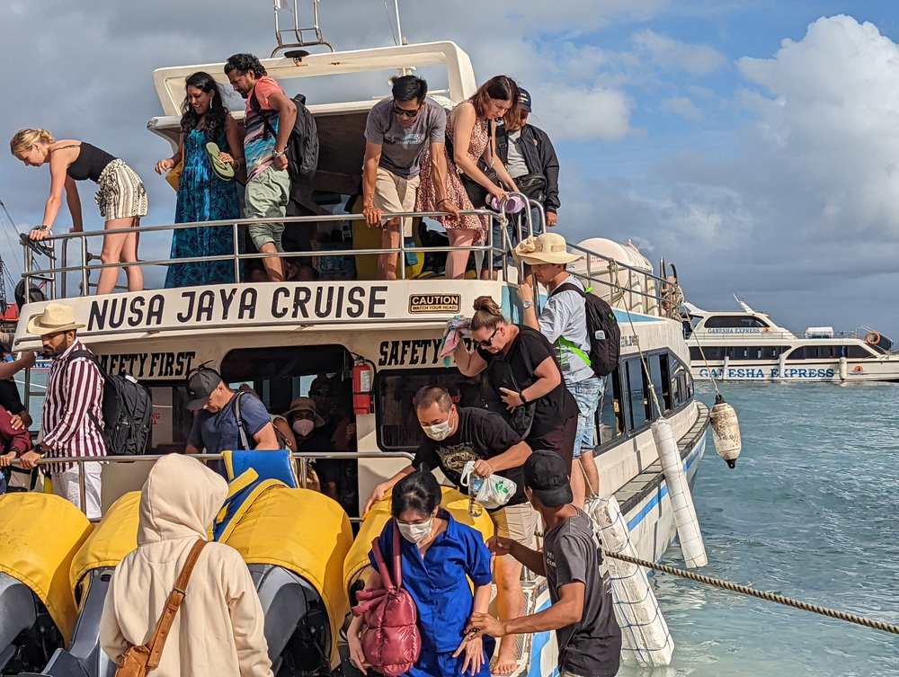 tourists on a boat to nusa penida