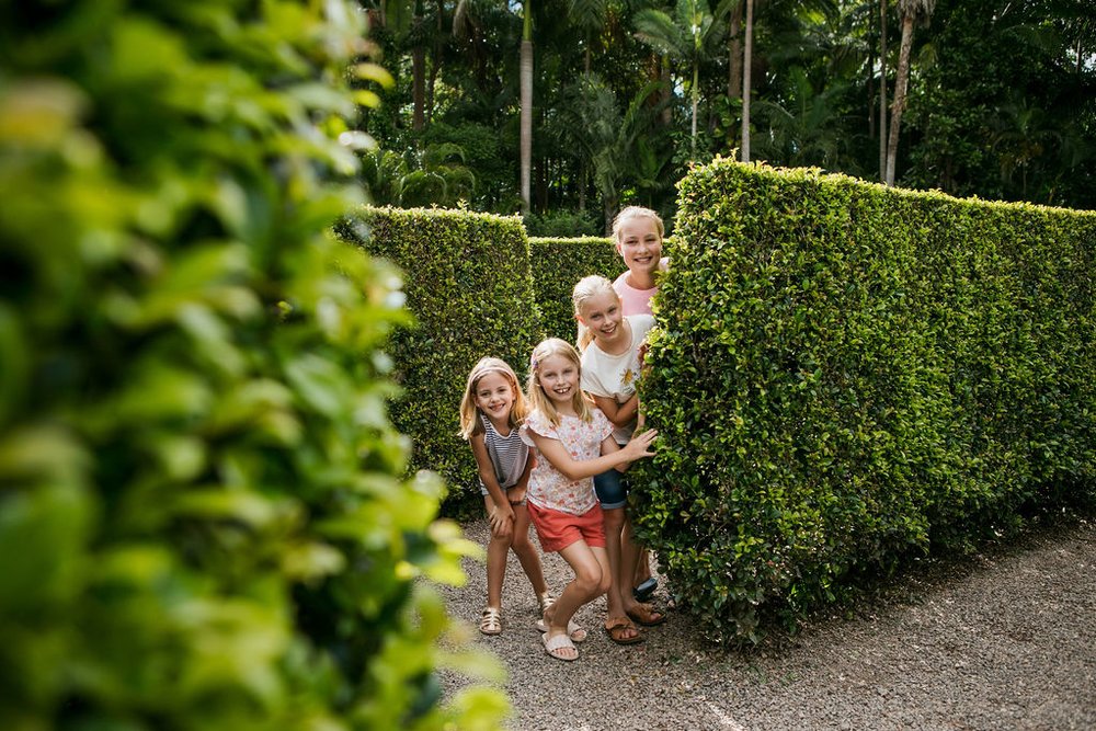 Kids posing for a photo while in the maze at Amaze World
