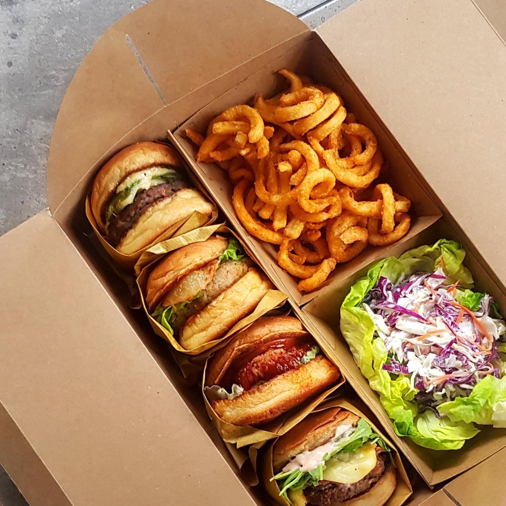 Burger, fries and salad in a carton