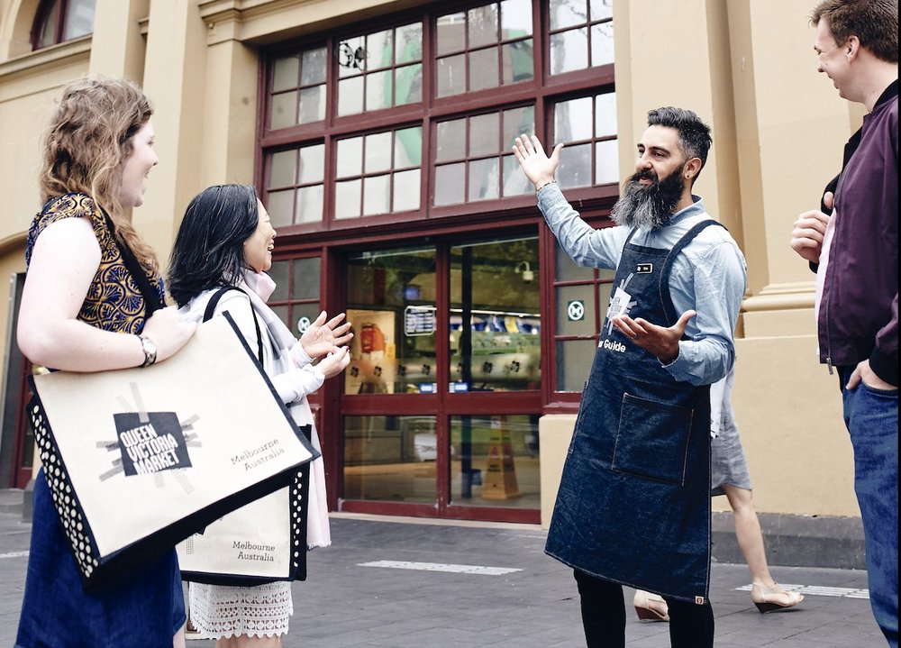 a foodie guide touring people around the Queen Victoria Market in Melbourne
