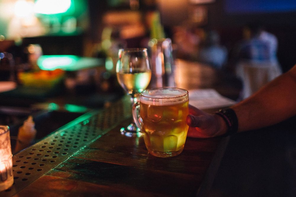 a hand holding a glass of beer