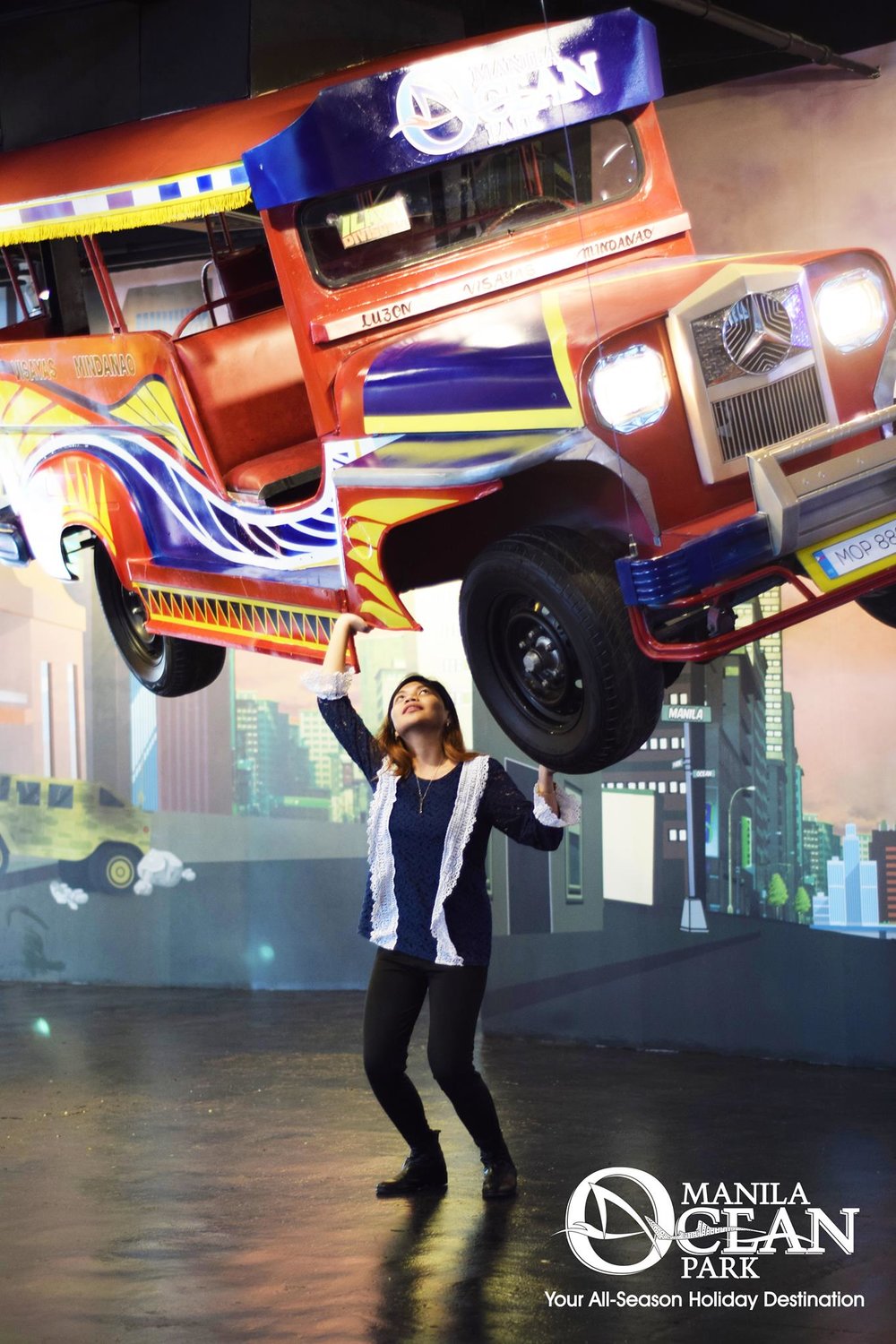Illusion of a girl lifting a jeepney