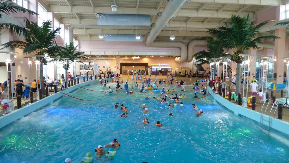 People swimming in a large pool in a water park