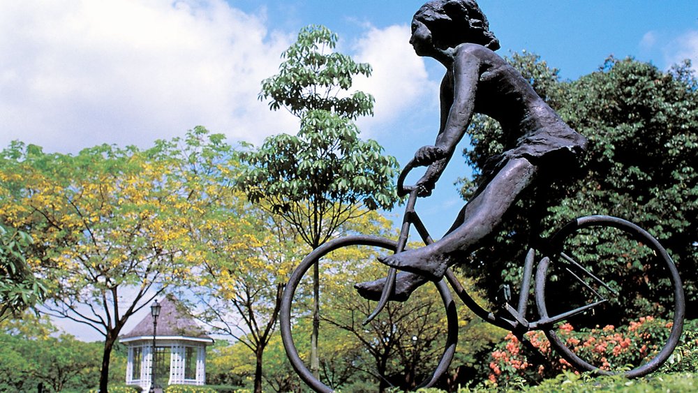 Girl riding a bike statue
