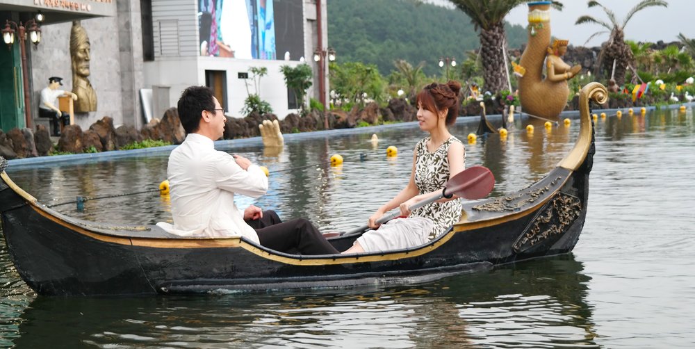Man and woman on a boat in Jeju Venice Land