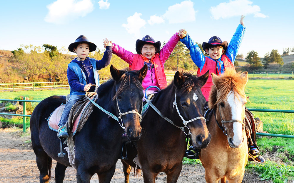Kids on horses in Jeju