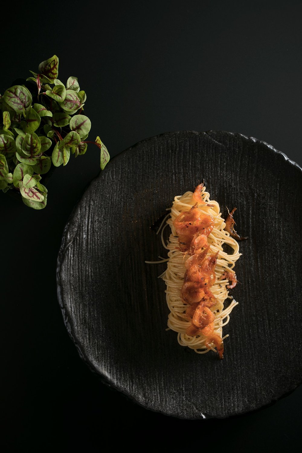 Noodle dish in a black plate