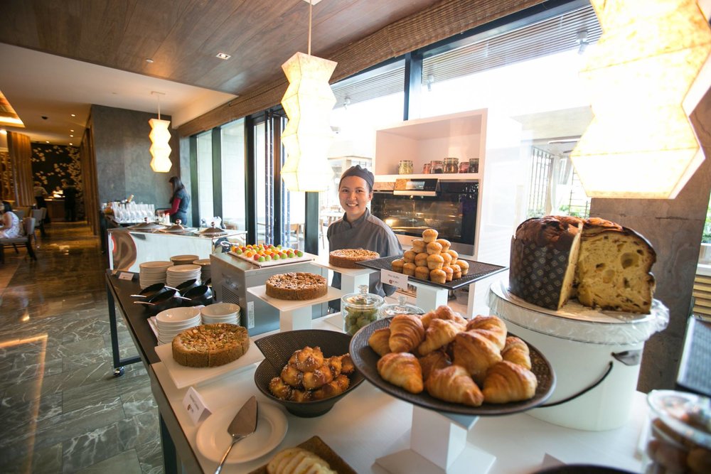 Pastry chef serving pastries in buffet