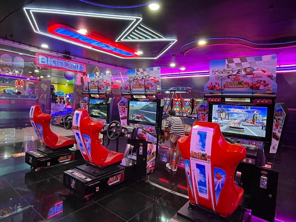 Arcade car games with pink neon lights
