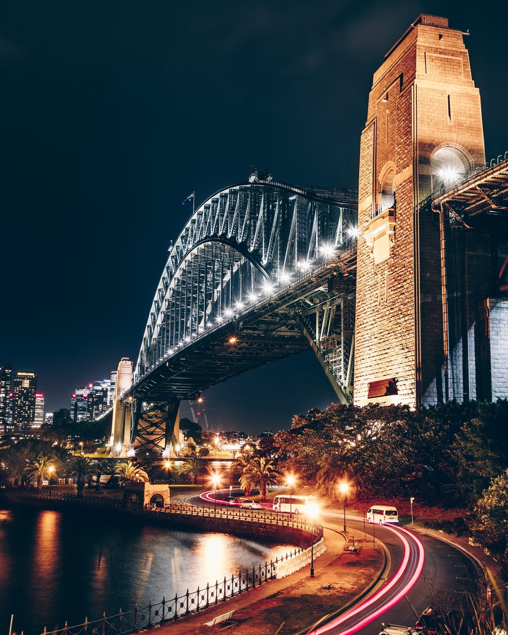 A road under a bridge at night