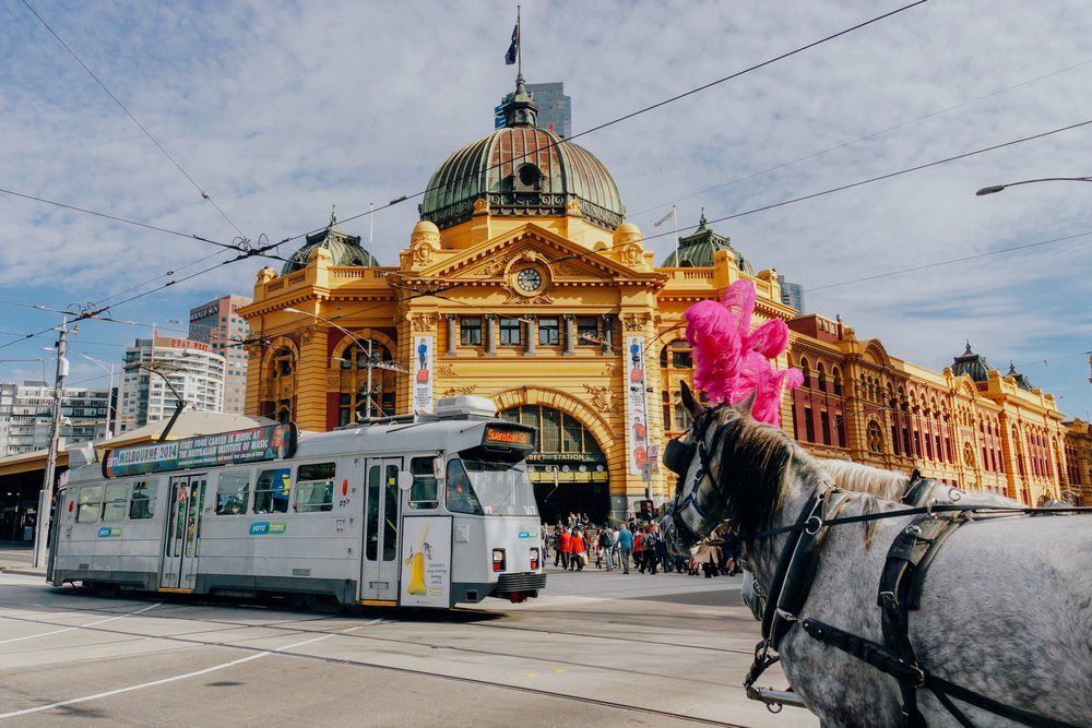 Horses and a tram passing by