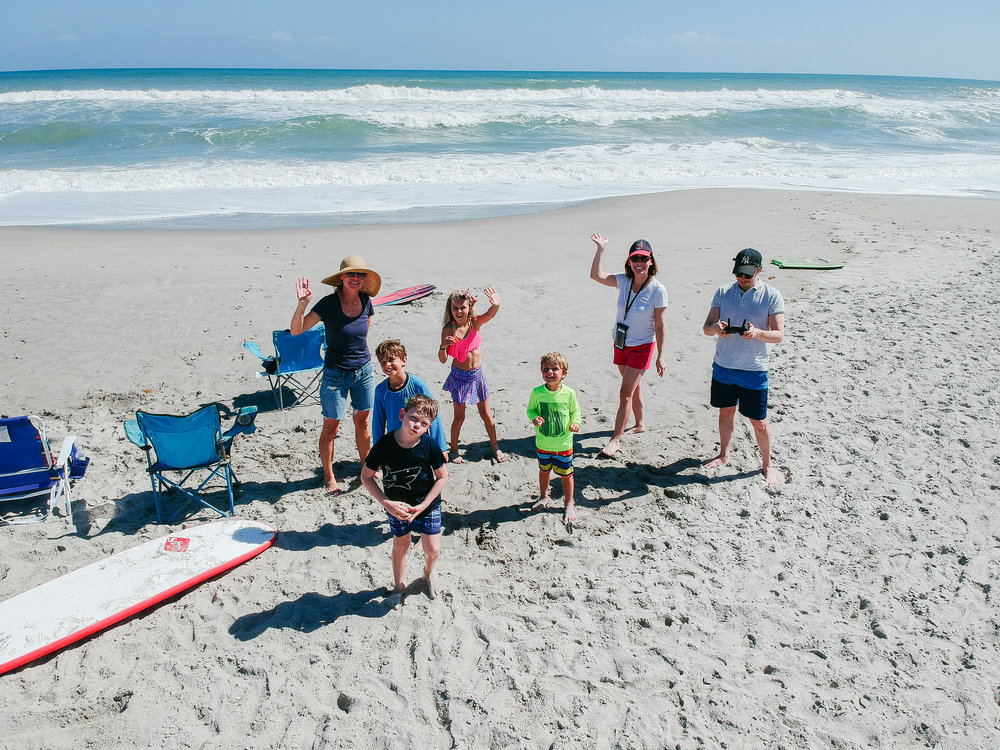 People happily waving to the camera
