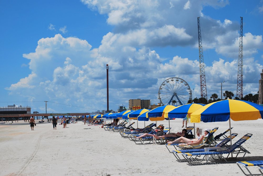 People lying under beach umbrellas on the beach