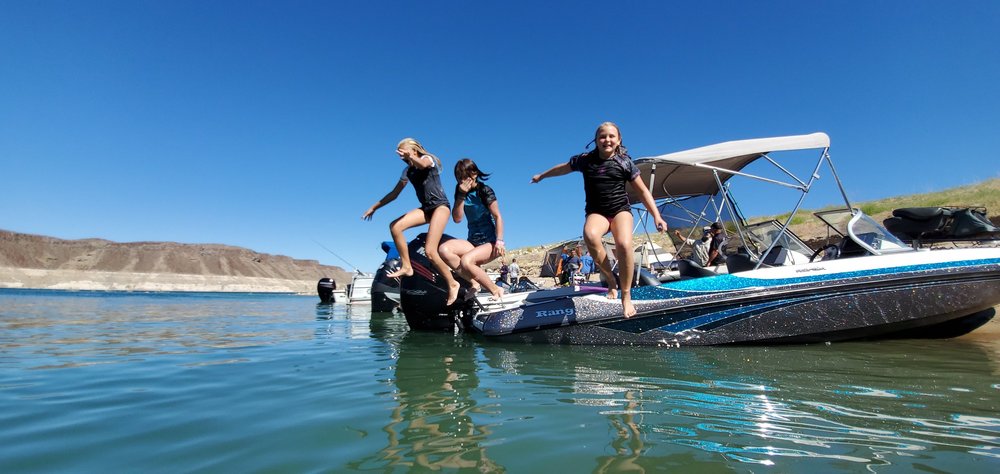 Kids jumping off a boat