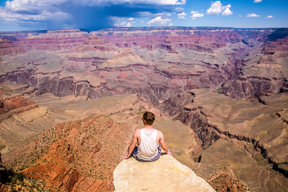 Man sitting on the edge of a cliff
