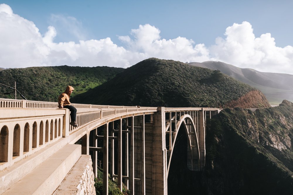 Man sitting on Bixby Bridge