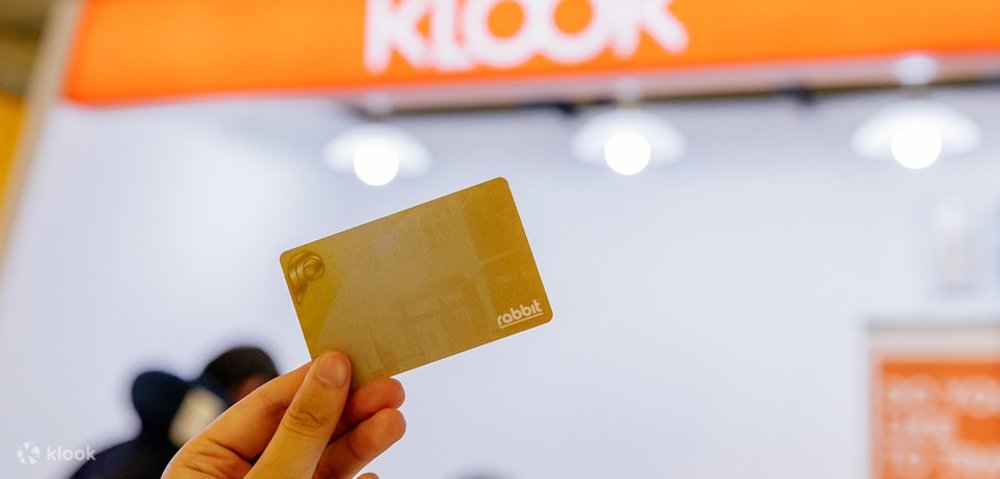 hand holding a gold bts rabbit card