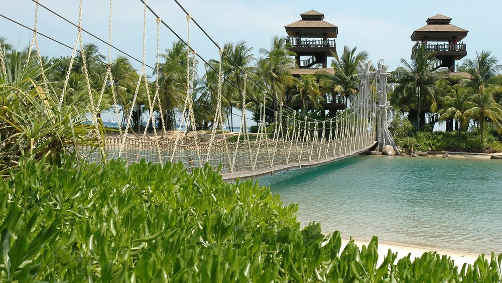 Crystal clear water under a hanging bridge