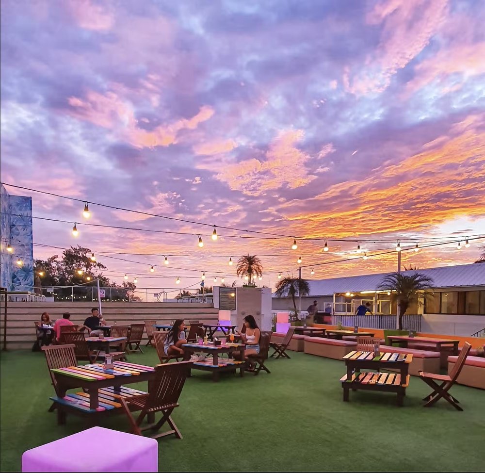Rooftop bar and restaurant under a pink sky