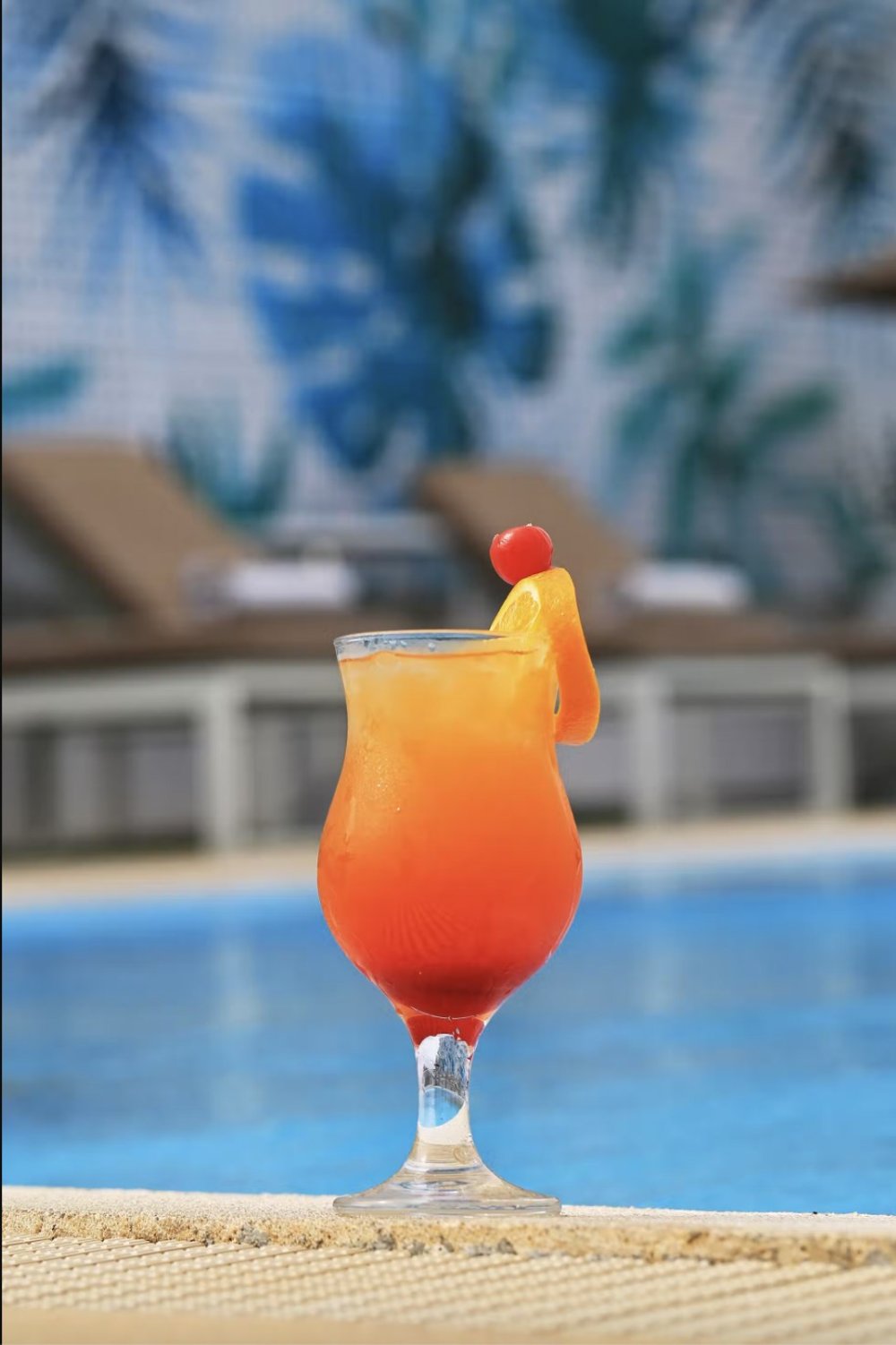 Orange juice beside the pool