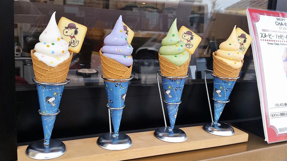 Four ice cream cones with different flavors of ice cream