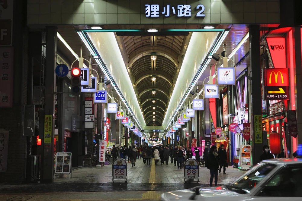 Lots of people walking through a shopping street