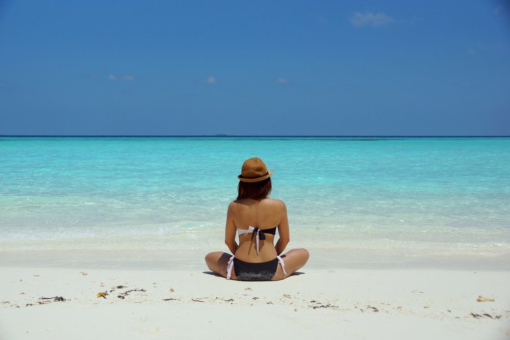 Woman sitting at sand