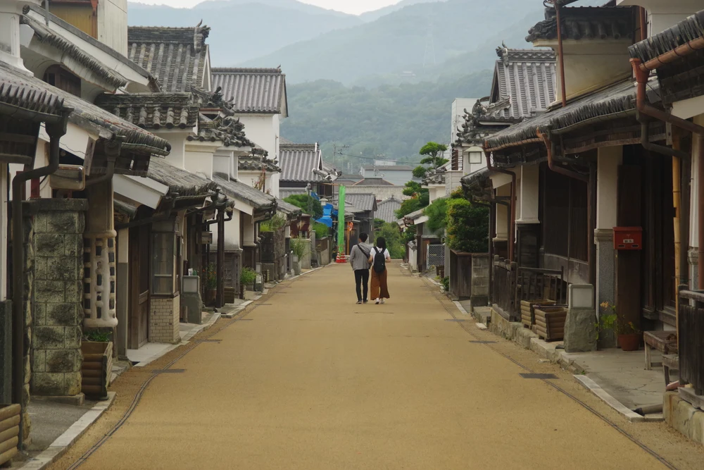 a couple walking along a quaint street in Udatsu