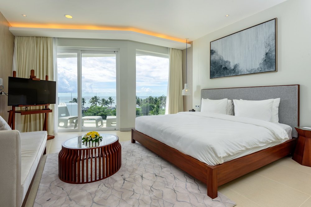 Master bed with white sheets