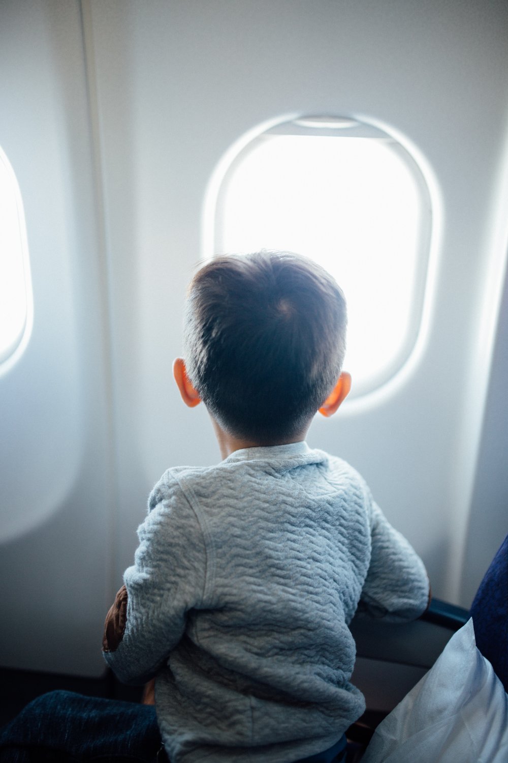 Child looking at airplane window