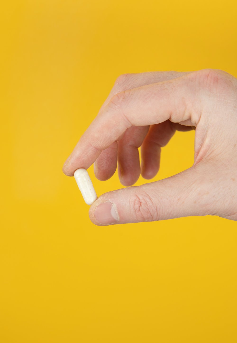 Yellow background with pill