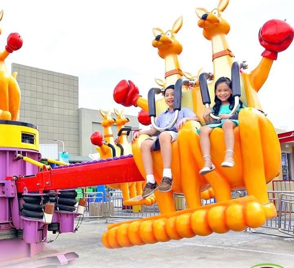Two kids riding in a kangaroo ride