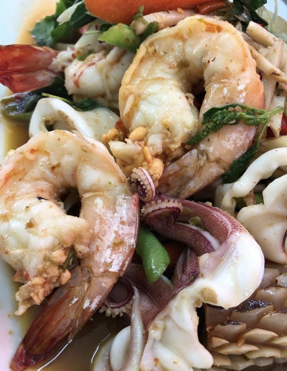 Different seafoods with greens