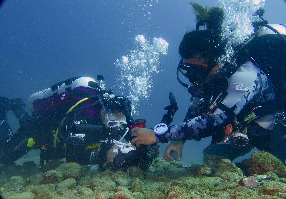 Two persons capturing coral reefs