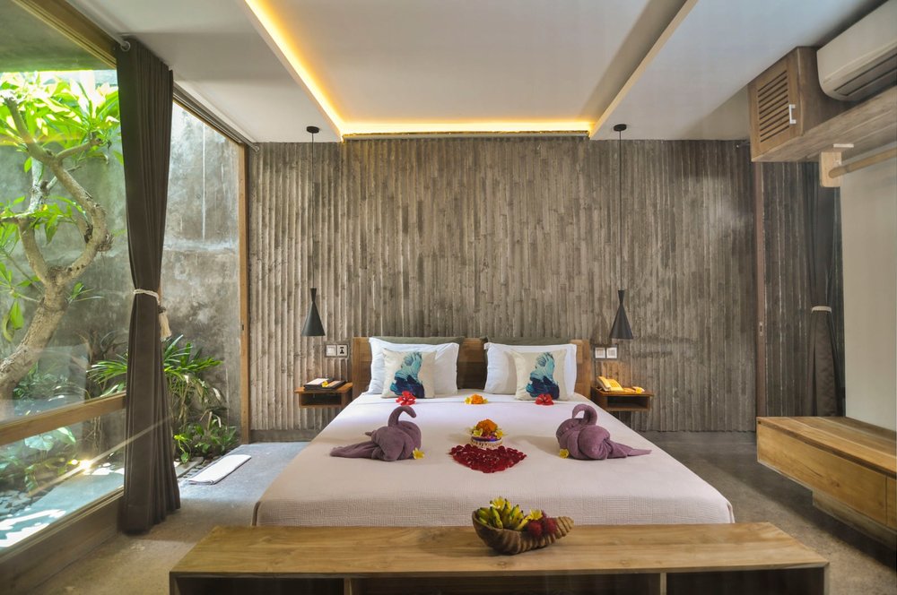 Purple towel swan on bed