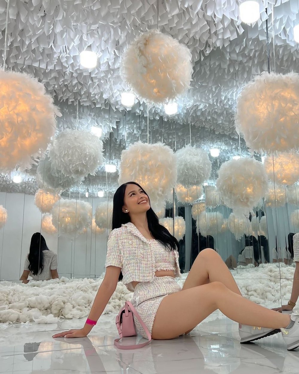 Girl sitting in a room full of feather