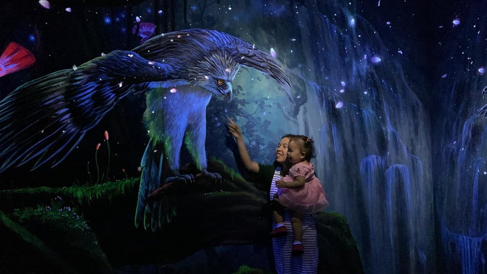 Mom and baby with a big 3D eagle mural