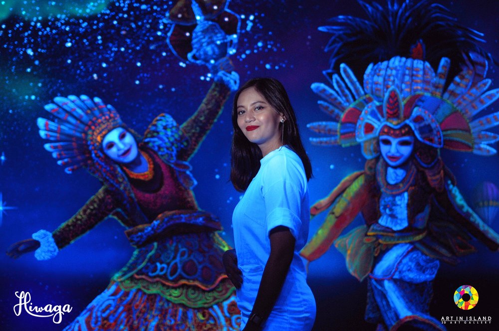 Girl smiling at the camera with Maskara in her background