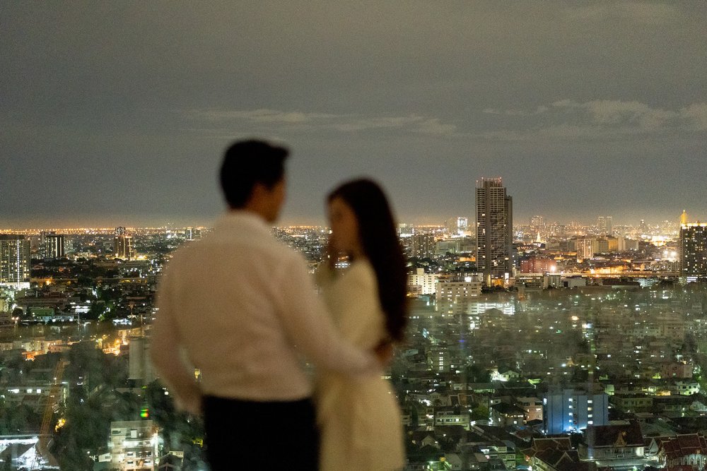 Couple standing in front of the Bangkok skyline view